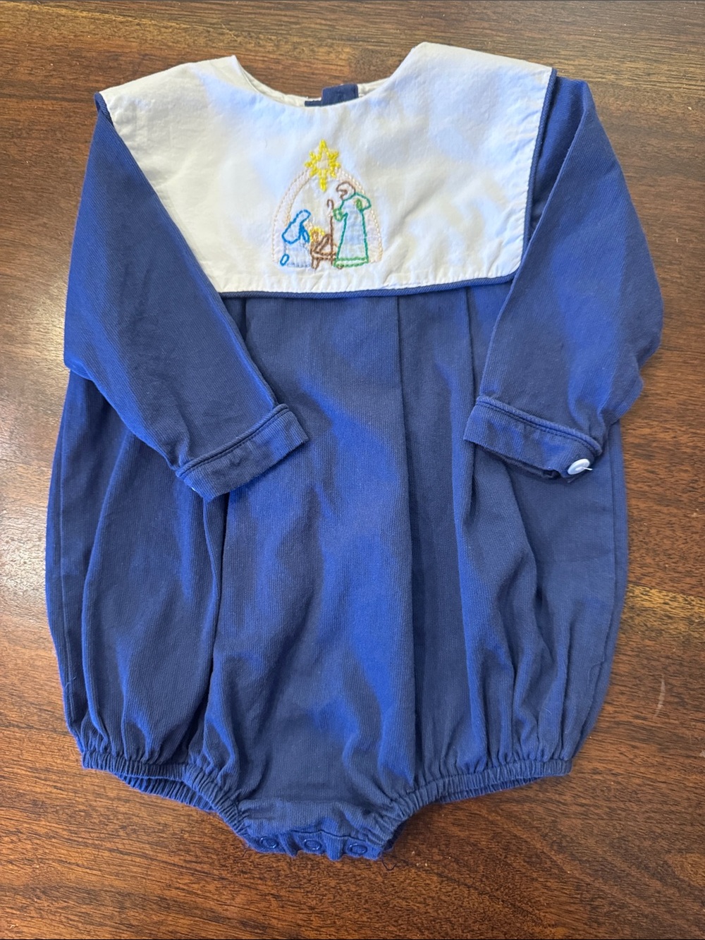The smocking Place Navy Blue Baby Romper with White Yoke and Nativity Embroidery